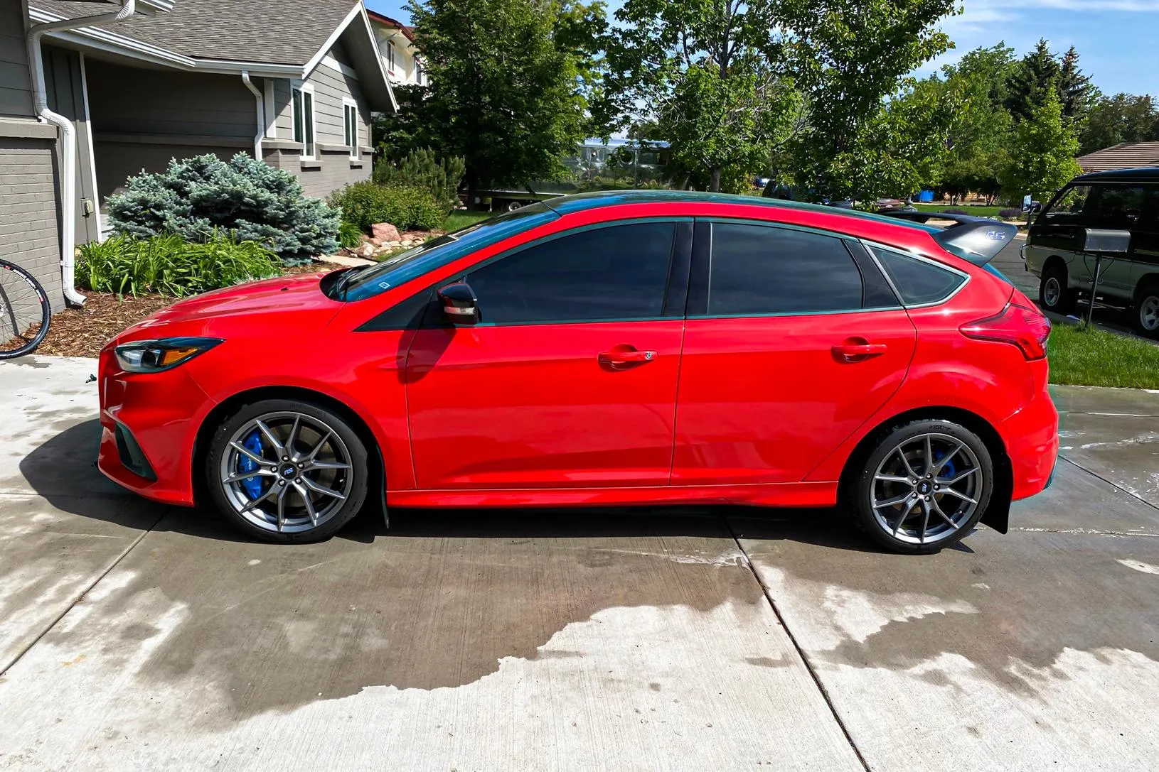 Red hatchback parked in a driveway