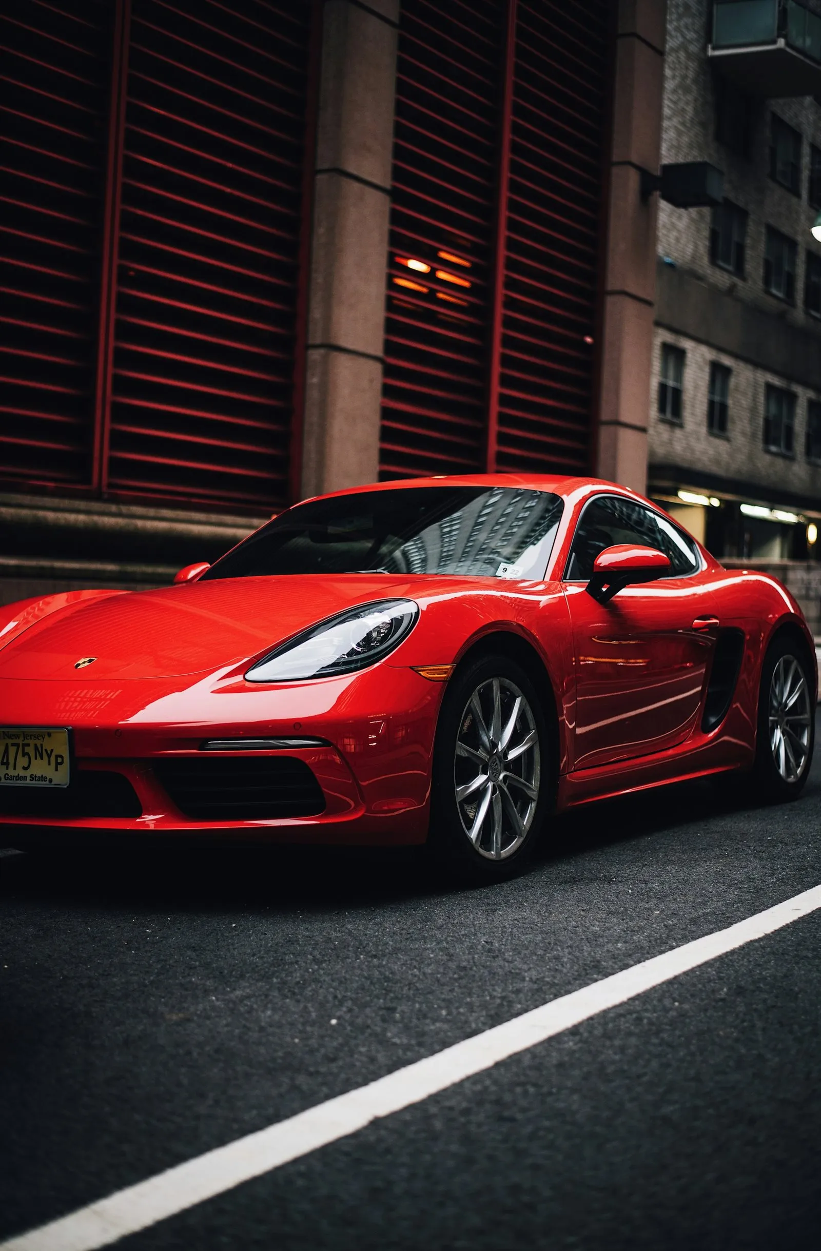 Red sports car parked on a city street