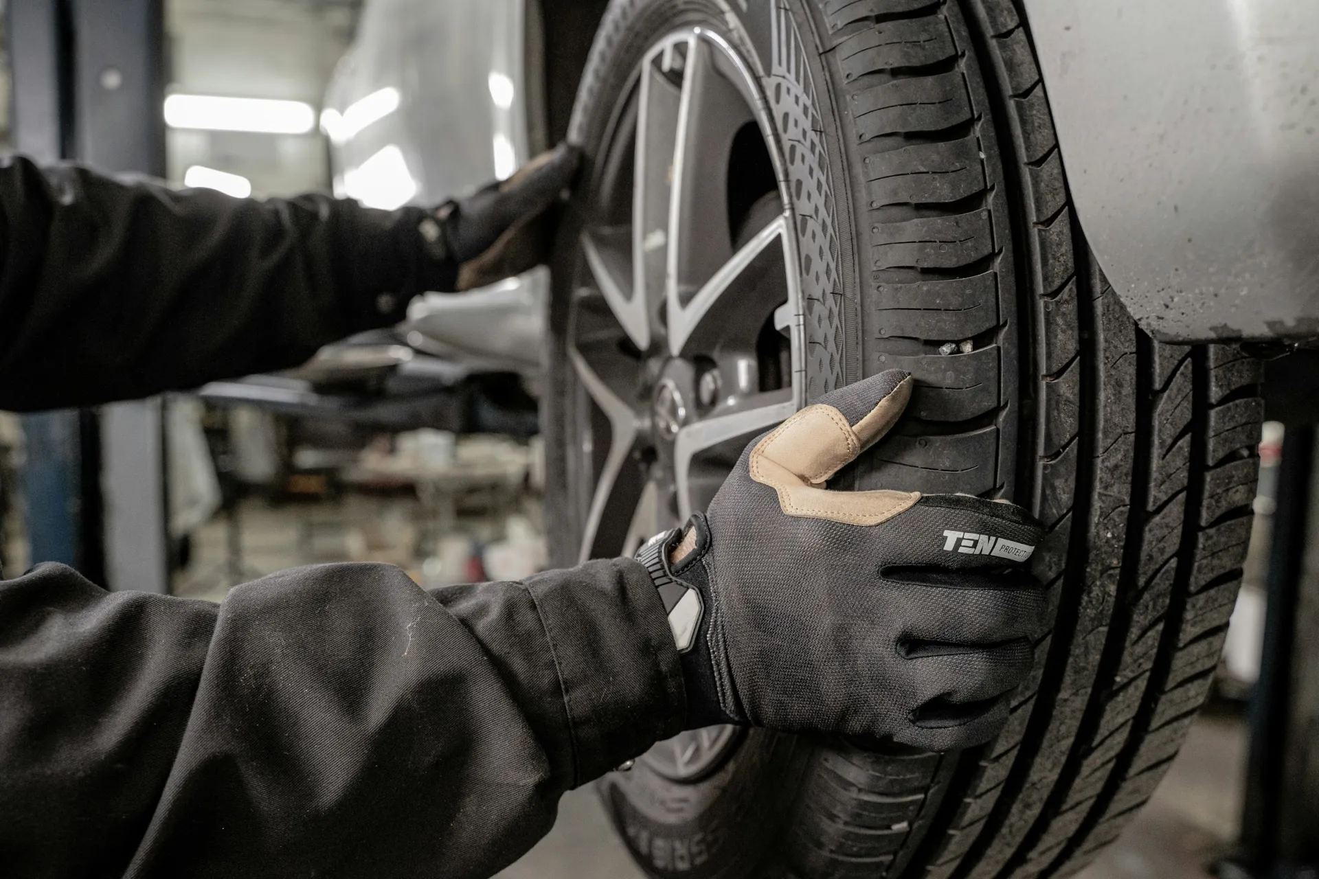 Technician checking a tire on a vehicle